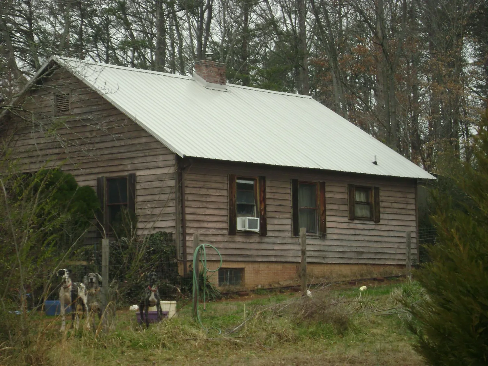 White metal roof on an old wood sided farmhouse, from a Asphalt Shingle Roof Repair job in Westmoreland City